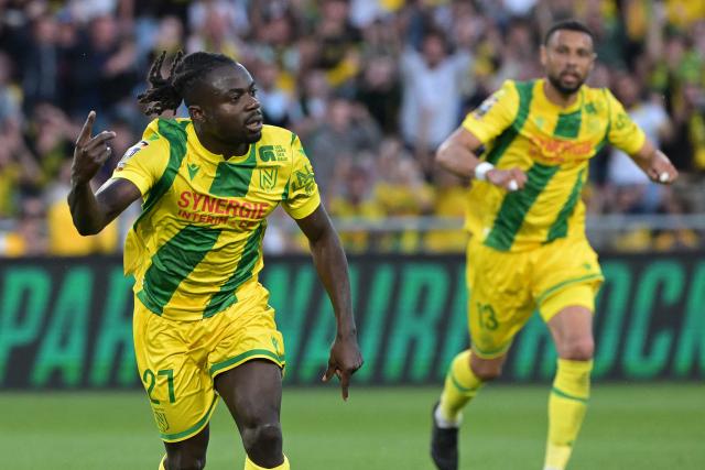 Nantes' Nigerian forward #27 Moses Simon (L) celebrates after scoring a penalty kick for the opening goal  during the French L1 football match between FC Nantes and Montpellier Herault SC at the Stade de la Beaujoire–Louis Fonteneau in Nantes, western France on May 17, 2025. (Photo by Damien Meyer / AFP)