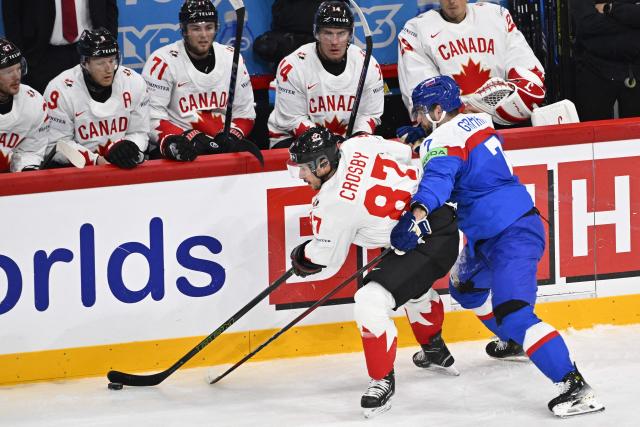 Canada's forward #87 Sidney Crosby and Slovakia's defender #07 Mario Grman vie for the puck during the IIHF Men's Ice Hockey World Championship match between Canada and Slovakia in Stockholm, on May 17, 2025. (Photo by Anders WIKLUND / TT News Agency / AFP) / Sweden OUT