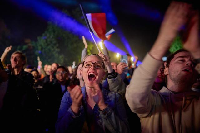 Fans of the singer representing France gather at a fan zone on Place de la Bastille to watch a broadcast of the grand final of the Eurovision Song Contest 2025, which takes place in Basel, Switzerland, in Paris on May 17, 2025. (Photo by Kiran RIDLEY / AFP)