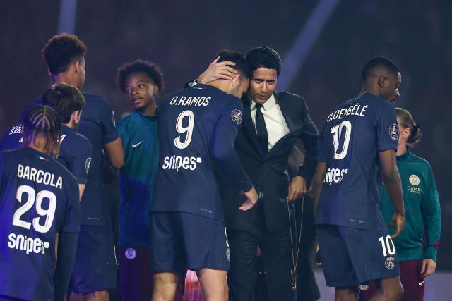 Paris Saint Germain's Qatari president Nasser al-Khelaifi (C-R) reacts with Paris Saint-Germain's Portuguese forward #09 Goncalo Ramos after PSG won the match and during a celebration of their championship title  following the French L1 football match between Paris Saint-Germain (PSG) and AJ Auxerre at The Parc des Princes Stadium in Paris on May 17, 2025. (Photo by FRANCK FIFE / AFP)