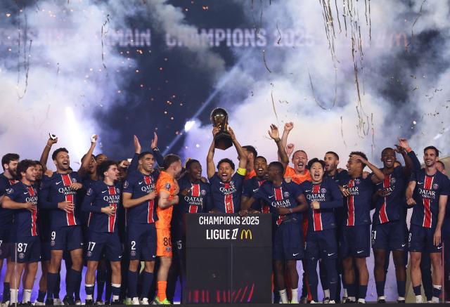Paris Saint-Germain's Brazilian defender #05 Marquinhos (C) lifts the trophy as PSG celebrate their championship title following the French L1 football match between Paris Saint-Germain (PSG) and AJ Auxerre at The Parc des Princes Stadium in Paris on May 17, 2025. (Photo by FRANCK FIFE / AFP)