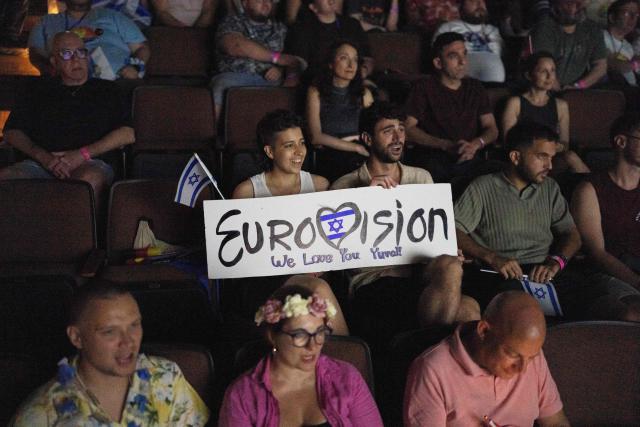 People react as they watch the 2025 Eurovision Song Contest finals being screened at a community center in Tel Aviv, Israel, on May 17, 2025. Austria's JJ won the 2025 Eurovision Song Contest on May 18, with his operatic song "Wasted Love" triumphing at the world's biggest live music television event. After the nail-biting drama as the votes were revealed running into Sunday morning, Austria finished with 436 points, ahead of Israel on 357 and Estonia on 356. (Photo by Maya Levin / AFP)