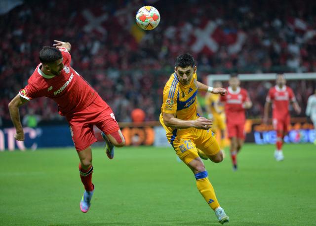Toluca's Portuguese forward #26 Paulinho and Tigres' defender #27 Jesus Angulo fight for the ball during the Liga MX Clausura tournament semi-final second leg football match between Toluca and Tigres at the Nemesio Diez Stadium in Toluca, Mexico on May 17, 2025. (Photo by Mario Vazquez / AFP)