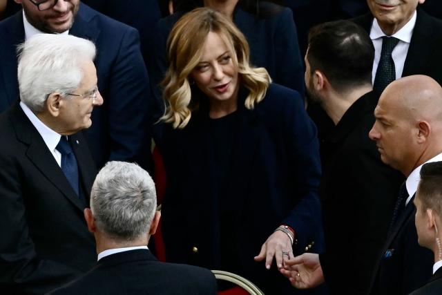 Italy's Prime Minister Giorgia Meloni speaks with Italy's President Sergio Matarealla (L) and Ukraine's President Volodymyr Zelensky as they arrive to attend a Holy Mass for the Beginning of the Pontificate of Pope Leo XIV, in St Peter's square in The Vatican on May 18, 2025. (Photo by Filippo MONTEFORTE / AFP)