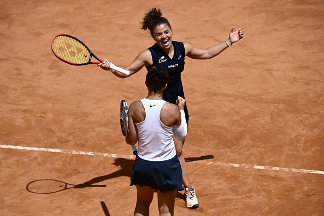 Italy's Jasmine Paolini (up) and Sara Errani (bottom) celebrate at the end of their women's doubles final match against Russia's Veronika Kudermetova and Belgium’s Elise Mertens for the ATP Rome Open tennis tournament at Foro Italico in Rome on May 18, 2025. (Photo by Filippo MONTEFORTE / AFP)