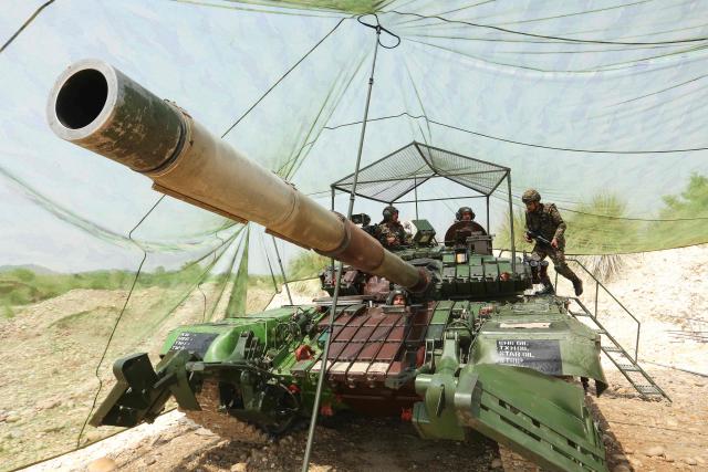 Indian army soldies pictured atop a tank at Akhnoor sector near the Line of Control (LoC) in Jammu region on May 19, 2025. (Photo by Mukesh GUPTA / AFP)