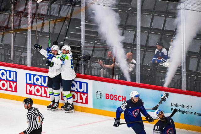 Slovenia’s defender #46 Matic Torok celebrates with Slovenia’s forward #55 Robert Sabolic after scoring 1-3 during the IIHF Men's Ice hockey World Championship match between France and Slovenia in Stockholm, on May 19, 2025. (Photo by Jonathan NACKSTRAND / AFP)