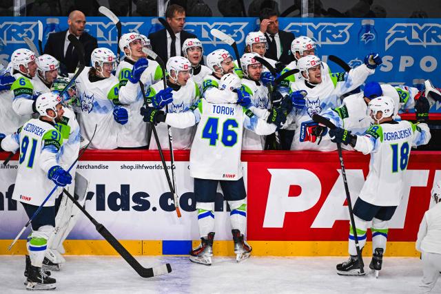 Slovenia’s defender #46 Matic Torok celebrates with his teammates after scoring 1-3 during the IIHF Men's Ice hockey World Championship match between France and Slovenia in Stockholm, on May 19, 2025. (Photo by Jonathan NACKSTRAND / AFP)