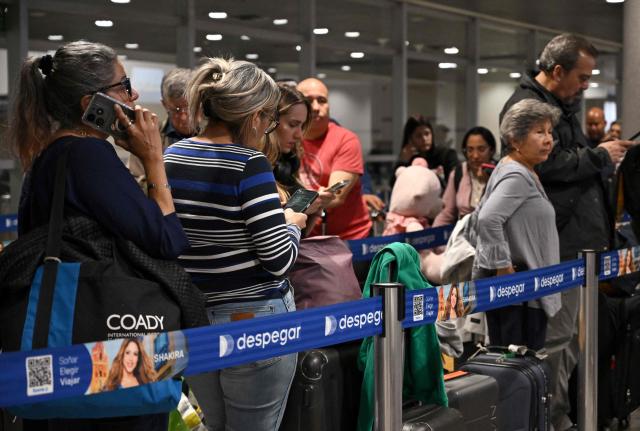 Venezuelan passengers await news after the cancellation of their flights to Caracas at El Dorado International Airport in Bogota on May 19, 2025. Venezuela announced on Monday the suspension of flights with Colombia after denouncing the arrival of "mercenaries" by this route with the plan to "sabotage" the elections of governors and parliamentarians on May 25. (Photo by Raul ARBOLEDA / AFP)