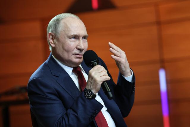 In this pool photograph distributed by the Russian state agency Sputnik, Russian President Vladimir Putin gestures as he talks with students at the Sirius Educational Center in Sochi on May 19, 2025, after a telephone conversation with US President Donald Trump. (Photo by Alexander KAZAKOV / POOL / AFP)