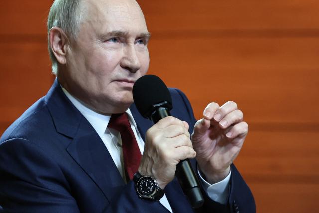 In this pool photograph distributed by the Russian state agency Sputnik, Russian President Vladimir Putin gestures as he talks with students at the Sirius Educational Center in Sochi on May 19, 2025, after a telephone conversation with US President Donald Trump. (Photo by Alexander KAZAKOV / POOL / AFP)