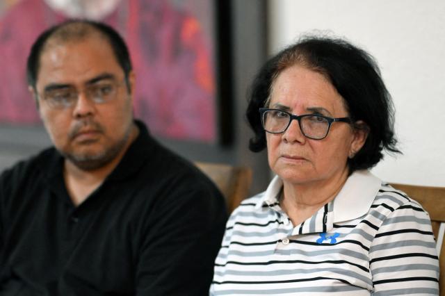 Eleonora Alfaro (R), mother of lawyer Ruth Lopez of the human rights group Cristosal, looks on next to Louis Benavides, partner of Lopez, during a press conference to report on the arrest of her daughter by Salvadoran police in Santa Tecla, El Salvador, on May 19, 2025. The Salvadoran lawyer who denounced corruption in Nayib Bukele's government and assisted the 252 Venezuelan migrants deported by the United States and imprisoned in El Salvador was arrested, reported Monday the human rights group Cristosal, where she works. (Photo by Marvin RECINOS / AFP)