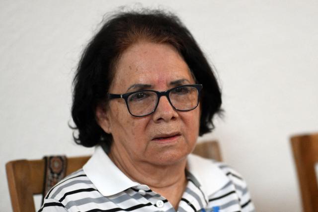 Eleonora Alfaro, mother of lawyer Ruth Lopez of the human rights group Cristosal, gestures during a press conference to report on the arrest of her daughter by Salvadoran police in Santa Tecla, El Salvador, on May 19, 2025. The Salvadoran lawyer who denounced corruption in Nayib Bukele's government and assisted the 252 Venezuelan migrants deported by the United States and imprisoned in El Salvador was arrested, reported Monday the human rights group Cristosal, where she works. (Photo by Marvin RECINOS / AFP)