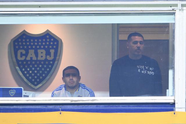 Boca Juniors' Presidente Juan Roman Riquelme (R) gestures next to his brother Cristian during the Argentine Professional Football League 2025 Apertura Tournament quarter-final match between Boca Juniors and Independiente at La Bombonera stadium in Buenos Aires on May 19, 2025. (Photo by Luis ROBAYO / AFP)