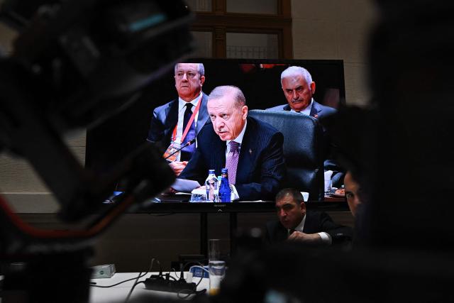 A screen at the press center shows Turkish President Recep Tayyip Erdogan during the informal summit of the Organization of Turkic States on May 21, 2025 at the Varkert Bazar cultural center in Budapest. (Photo by Attila KISBENEDEK / AFP)