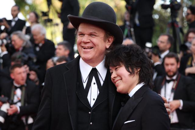 US actor John C. Reilly and Italian producer Alex C Lo arrive for the screening of the film “Testa o croce?” (Heads or Tails?) at the 78th edition of the Cannes Film Festival in Cannes, southern France, on May 21, 2025. (Photo by Valery HACHE / AFP)