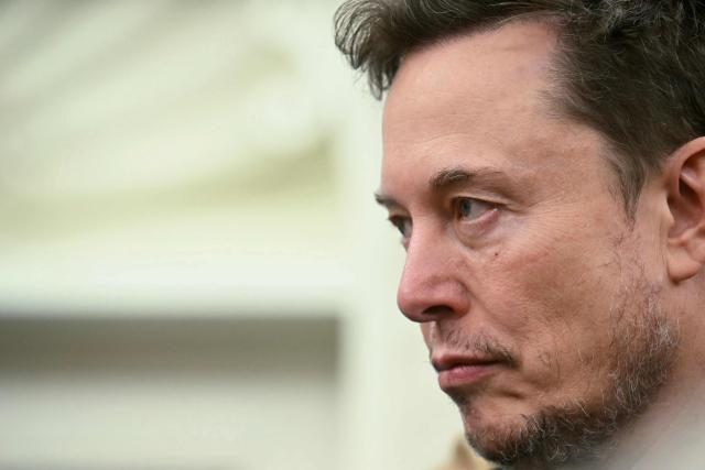 Co-leader of the Department of Government Efficiency Elon Musk looks on as US President Donald Trump meets with South African President Cyril Ramaphosa in the Oval Office of the White House in Washington, DC, on May 21, 2025. South African President Cyril Ramaphosa meets Donald Trump on Wednesday amid tensions over Washington's resettlement of white Afrikaners that the US president claims are the victims of "genocide." (Photo by Jim WATSON / AFP)