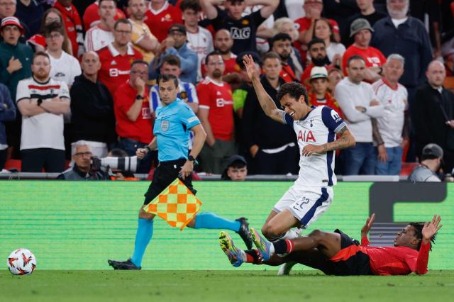 Tottenham Hotspur's Welsh forward #22 Brennan Johnson is tackled by Manchester United's Danish defender #13 Patrick Dorgu during the UEFA Europa League final football match between Tottenham Hotspur and Manchester United at San Mames stadium in Bilbao on May 21, 2025. (Photo by Thomas COEX / AFP)