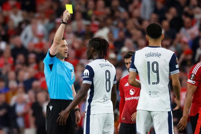 Tottenham Hotspur's Malian midfielder #08 Yves Bissouma is shown a yellow card by German referee Felix Zwayer during the UEFA Europa League final football match between Tottenham Hotspur and Manchester United at the San Mames stadium in Bilbao on May 21, 2025. (Photo by Pierre-Philippe MARCOU / AFP)