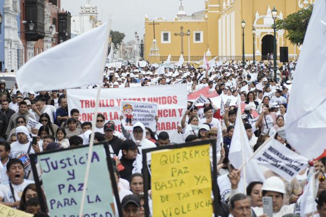 Demonstrators march during a protest against the government, the organized crime and call for the lifting of mining restrictions in Trujillo, Peru on May 21, 2025. (Photo by Steffano Palomino / AFP)