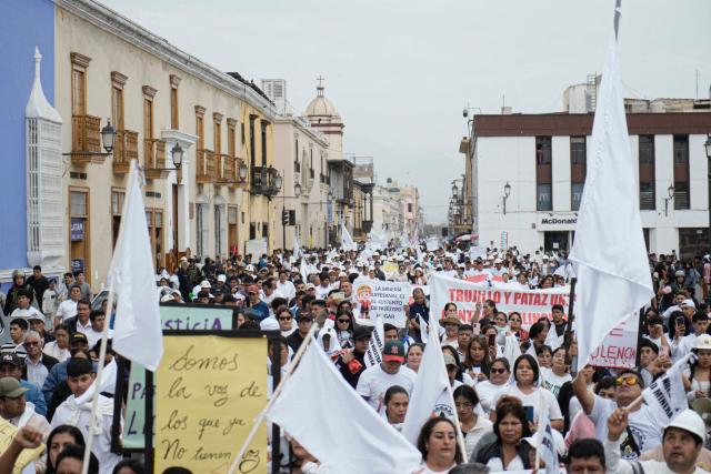Demonstrators march during a protest against the government, the organized crime and calling for the lifting of mining restrictions in Trujillo, Peru on May 21, 2025. (Photo by Steffano Palomino / AFP)