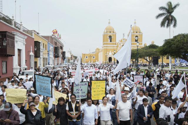 Demonstrators march during a protest against the government, the organized crime and calling for the lifting of mining restrictions in Trujillo, Peru on May 21, 2025. (Photo by Steffano Palomino / AFP)