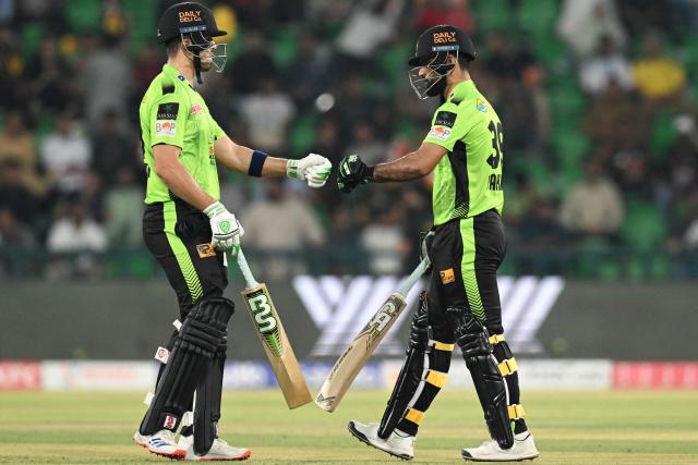 Lahore Qalandars' Fakhar Zaman (R) and teammate Muhammad Naeem bumps fists during the Pakistan Super League (PSL) Twenty20 cricket eliminator match between Lahore Qalandars and Karachi Kings at the Qaddafi Cricket Stadium in Lahore on May 22, 2025. (Photo by Aamir QURESHI / AFP)