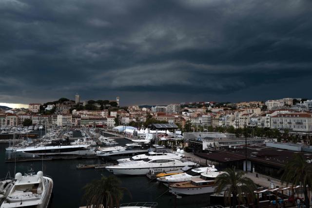 A dark arcus cloud forms in the distant sky, as luxury yachts sit docked in the old port of Cannes, during the 78th edition of the Cannes Film Festival in Cannes, southern France, on May 22, 2025. (Photo by Valery HACHE / AFP)