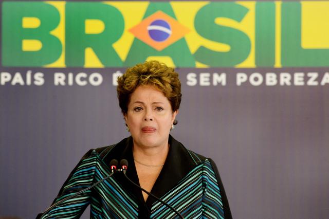 (FILES) Brazilian President Dilma Rousseff cries while delivering a speech during the ceremony presenting the final report of the National Truth Commission (CNV) --which investigates those responsible for human rights violations between 1946 and 1988 in the country-- at the Planalto Palace in Brasilia, Brazil, on December 10, 2014. The Brazilian state on May 22, 2025, officially apologized for the torture meted out to former president Dilma Rousseff by the military dictatorship in power when she was a young militant in the 1970s. (Photo by Evaristo SA / AFP)