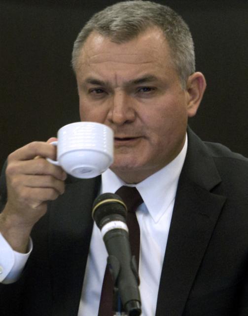 (FILES) The Federal Secretary of Public Security of Mexico, Genaro Garcia Luna, drinks coffee at the Mexican Senate house, on November 29, 2012. A US court on May 22, 2025, ordered a convicted former Mexican security chief and his wife to pay more than $2.4 billion to their country in a civil suit, Mexico's government said. Mexico sued Genaro Garcia Luna, who is imprisoned in the United States, and his wife for alleged corruption and money laundering involving public contracts. (Photo by Pedro PARDO / AFP)