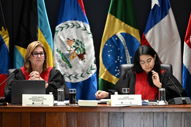 Costa Rican Nancy Hernandez Lopez (L), President of the Inter-American Court of Human Rights, and Judge Veronica Gomez attend a hearing in the case against Peru for the forced sterilization of a woman in 1997, which resulted in her death, in Guatemala City on May 22, 2025. (Photo by JOHAN ORDONEZ / AFP)