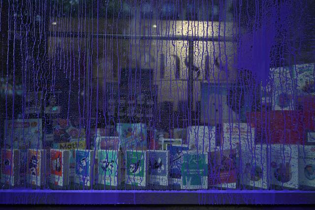 Purple paint covers the facade the facade of the publishing house Humasis following an action by activists from the feminist collective "NousToutes"  to protest against the publication of  Nicolas Bedos' latest book “La soif de honte” in Paris, on May 23, 2025. French actor-writer-director Nicolas Bedos was sentenced at first instance on October 2024 to one year in prison with six months suspended for sexually assaulting two women. (Photo by Leo VIGNAL / AFP)