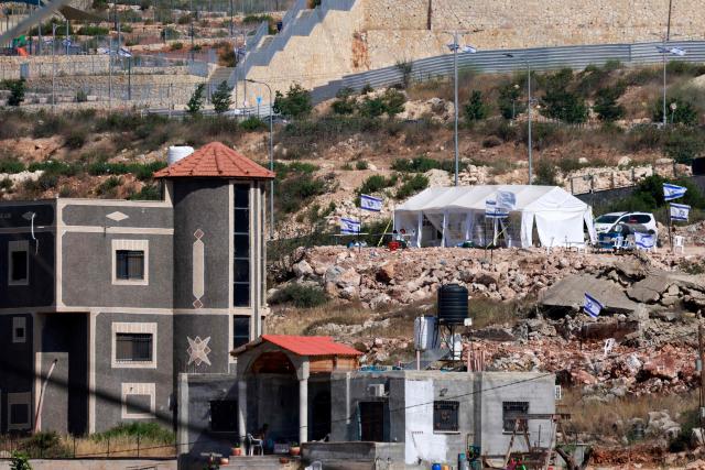 Tents are set up by Israeli settlers in the Palestinian village of Bruqin, outside the walls of an illegal settlement of the same name, in the occupied-West Bank on May 23, 2025. The West Bank is home to about three million Palestinians, but also some 500,000 Israelis living in settlements that are considered illegal under international law. (Photo by Jaafar ASHTIYEH / AFP)