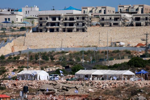 Tents are set up by Israeli settlers in the Palestinian village of Bruqin, outside the walls of an illegal settlement of the same name, in the occupied-West Bank on May 23, 2025. The West Bank is home to about three million Palestinians, but also some 500,000 Israelis living in settlements that are considered illegal under international law. (Photo by Jaafar ASHTIYEH / AFP)