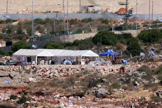 Tents are set up by Israeli settlers in the Palestinian village of Bruqin, outside the walls of an illegal settlement of the same name, in the occupied-West Bank on May 23, 2025. The West Bank is home to about three million Palestinians, but also some 500,000 Israelis living in settlements that are considered illegal under international law. (Photo by Jaafar ASHTIYEH / AFP)