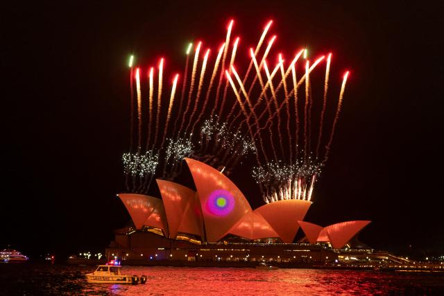 Fireworks explode as the sails of the Sydney Opera House are illuminated with lights at the start of the annual Vivid Sydney festival in Sydney on May 23, 2025. (Photo by Ayush Kumar / AFP)
