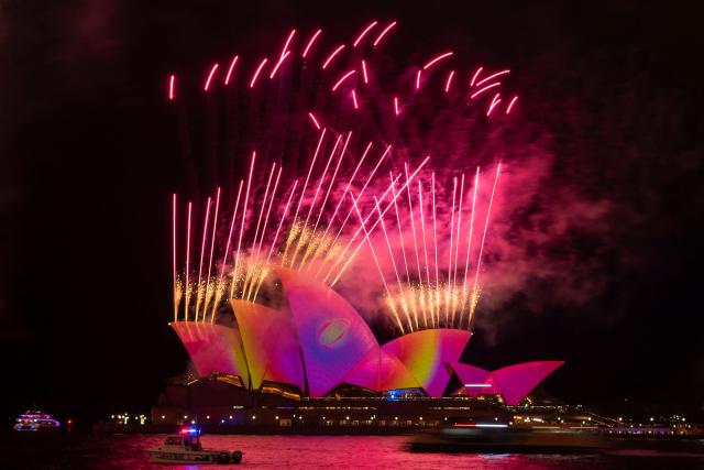 Fireworks explode as the sails of the Sydney Opera House are illuminated with lights at the start of the annual Vivid Sydney festival in Sydney on May 23, 2025. (Photo by Ayush Kumar / AFP)