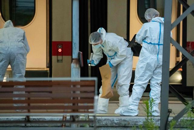 Forensic police officers investigate on the railway platform at Hamburg's main train station where at least 12 people have been injured in a knife attack on May 23, 2025. A knife attack at the main station in the German city of Hamburg left at least 12 people injured with some of them in a life-threatening condition, local emergency services said. (Photo by Jonas Walzberg / AFP)