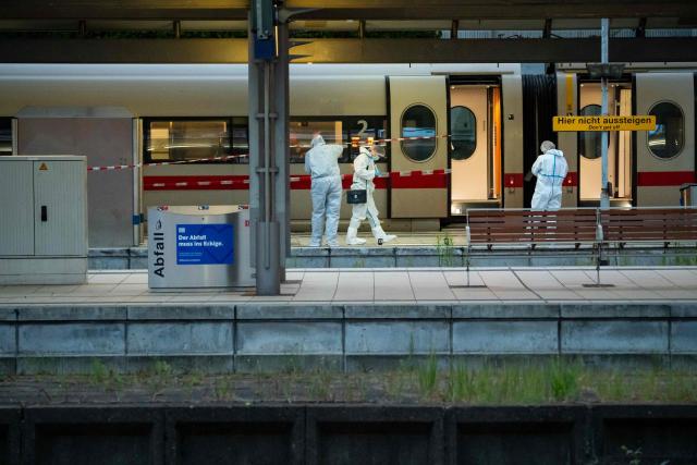 Forensic police officers investigate on the railway platform at Hamburg's main train station where at least 12 people have been injured in a knife attack on May 23, 2025. A knife attack at the main station in the German city of Hamburg left at least 12 people injured with some of them in a life-threatening condition, local emergency services said. (Photo by Jonas Walzberg / AFP)