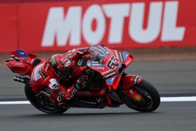 Ducati Lenovo Team's Italian MotoGP rider Francesco Bagnaia takes part in a practice session of the MotoGP British Grand Prix at Silverstone circuit in Northamptonshire, central England, on May 24, 2025. (Photo by Adrian Dennis / AFP)