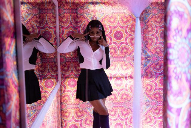 A customer poses for a photo in a decorated selfie room at Paper Nightclub in Abuja, on May 23, 2025. (Photo by OLYMPIA DE MAISMONT / AFP)