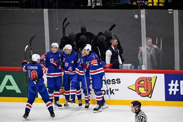 US forward #23 Michael Eyssimont (2nd R) celebrates with teammates after scoring the 0-3 goal during the IIHF Men's Ice Hockey World Championship semi-final match between Sweden and USA in Stockholm, on May 24, 2025. (Photo by Pontus LUNDAHL / TT NEWS AGENCY / AFP) / Sweden OUT