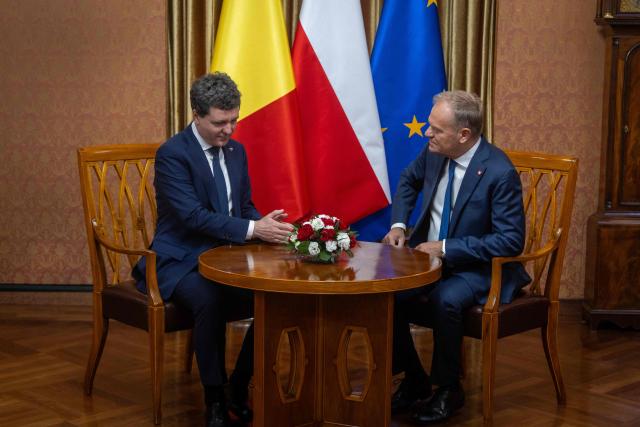 Poland's Prime Minister Donald Tusk (R) and Romania's President-elect Nicusor Dan have taken their seats for talks as they meet in Warsaw, Poland, on May 25, 2025. (Photo by Wojtek RADWANSKI / AFP)