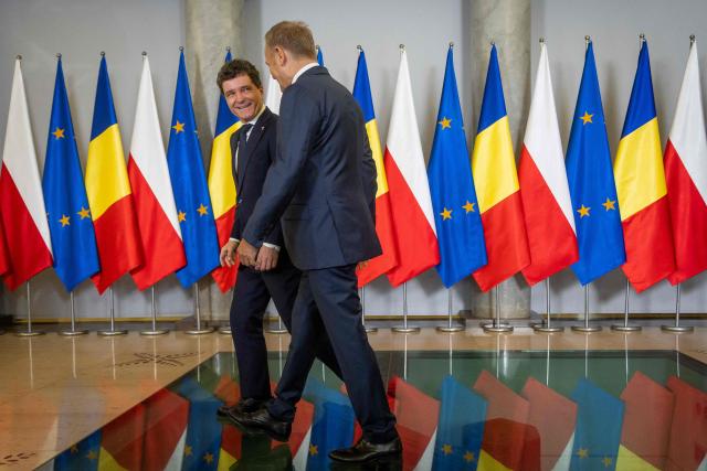 Poland's Prime Minister Donald Tusk (R) and Romania's President-elect Nicusor Dan meet in Warsaw, Poland, on May 25, 2025. (Photo by Wojtek RADWANSKI / AFP)