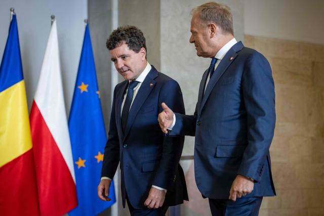 Poland's Prime Minister Donald Tusk (R) and Romania's President-elect Nicusor Dan meet in Warsaw, Poland, on May 25, 2025. (Photo by Wojtek RADWANSKI / AFP)