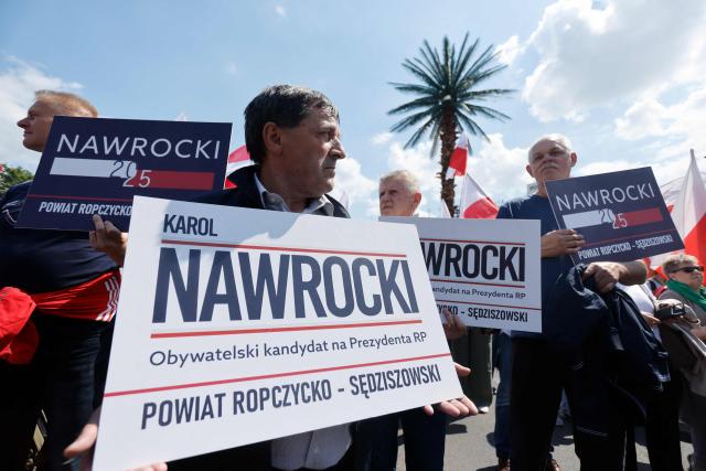 Supporters of Poland's presidential candidate Karol Nawrocki gather to attend a campaign rally in Warsaw on May 25, 2025, a week ahead of the second round of presidential elections. The June 1, 2025 runoff is expected to be a tight contest between pro-EU Warsaw mayor Rafal Trzaskowski, who is backed by the centrist government and won round one by a narrow margin, and nationalist historian Karol Nawrocki, who is supported by the main right-wing opposition. The election comes at a fraught moment for Europe, as Russia's invasion of Ukraine drags on and ties with Washington are under strain. (Photo by Wojtek RADWANSKI / AFP)