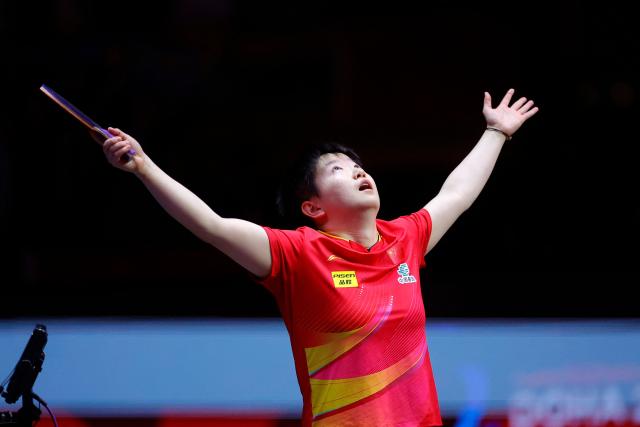 China's Sun Yingsha celebrates her win after the women's single final match of the ITTF World Table Tennis Championships finals in Doha on May 25, 2025. (Photo by Karim JAAFAR / AFP)