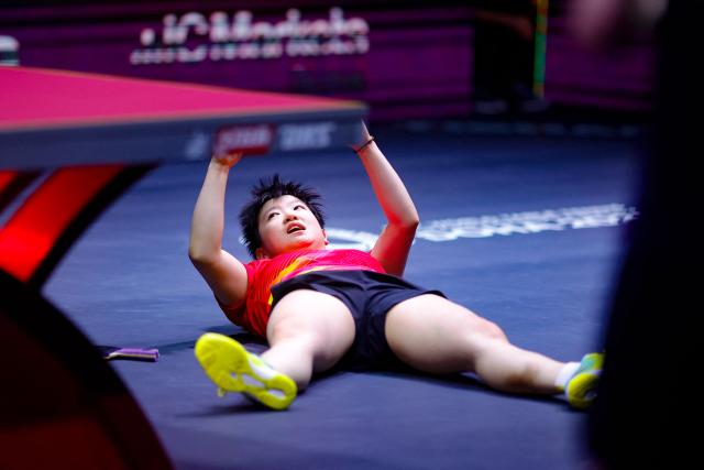 China's Sun Yingsha reacts after winning the women's single final match of the ITTF World Table Tennis Championships finals in Doha on May 25, 2025. (Photo by Karim JAAFAR / AFP)