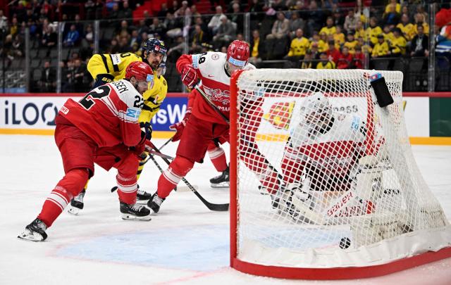 Sweden's forward #90 Marcus Johansson (2nd L) scores the 5-2 goal against Denmark's goalkeeper #80 Frederik Dichow (R) during the IIHF Men's Ice Hockey World Championship third place playoff match between Sweden and Denmark in Stockholm, on May 25, 2025. (Photo by Jonathan NACKSTRAND / AFP)