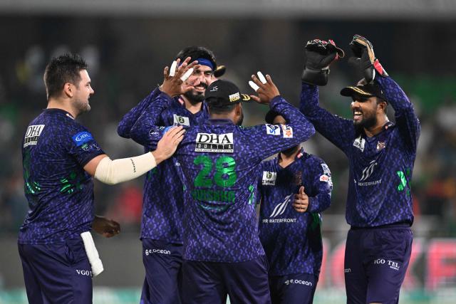 Quetta Gladiators' players celebrate after the dismissal of Lahore Qalandars' Mohammad Naeem during the Pakistan Super League (PSL) Twenty20 final cricket match between Lahore Qalandars and Quetta Gladiators at the Qaddafi Cricket Stadium in Lahore on May 25, 2025. (Photo by Aamir QURESHI / AFP)